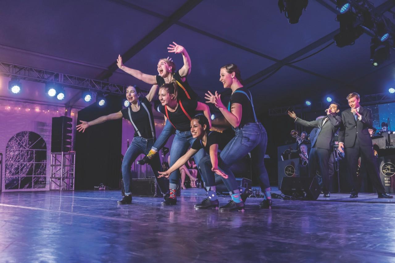 Coverage of Sam Biondollilo at the lighting table for the Dancing With bOp performance, and coverage of On Tap performing with bOp. Photographed for the Spring 2018 issue of BCM. On Tap performing with BC bOp. Here, On Tap performers L-R: Julia Nicholson, Michaela Simoneau, Amanda Sackmaster (base of piggyback), Jenie Rowland (on top of Amanda), and Emma Yates.